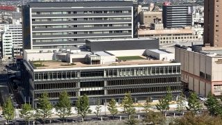 和歌山城から望む施設外観（屋上の展望テラスや野外ステージが見える）